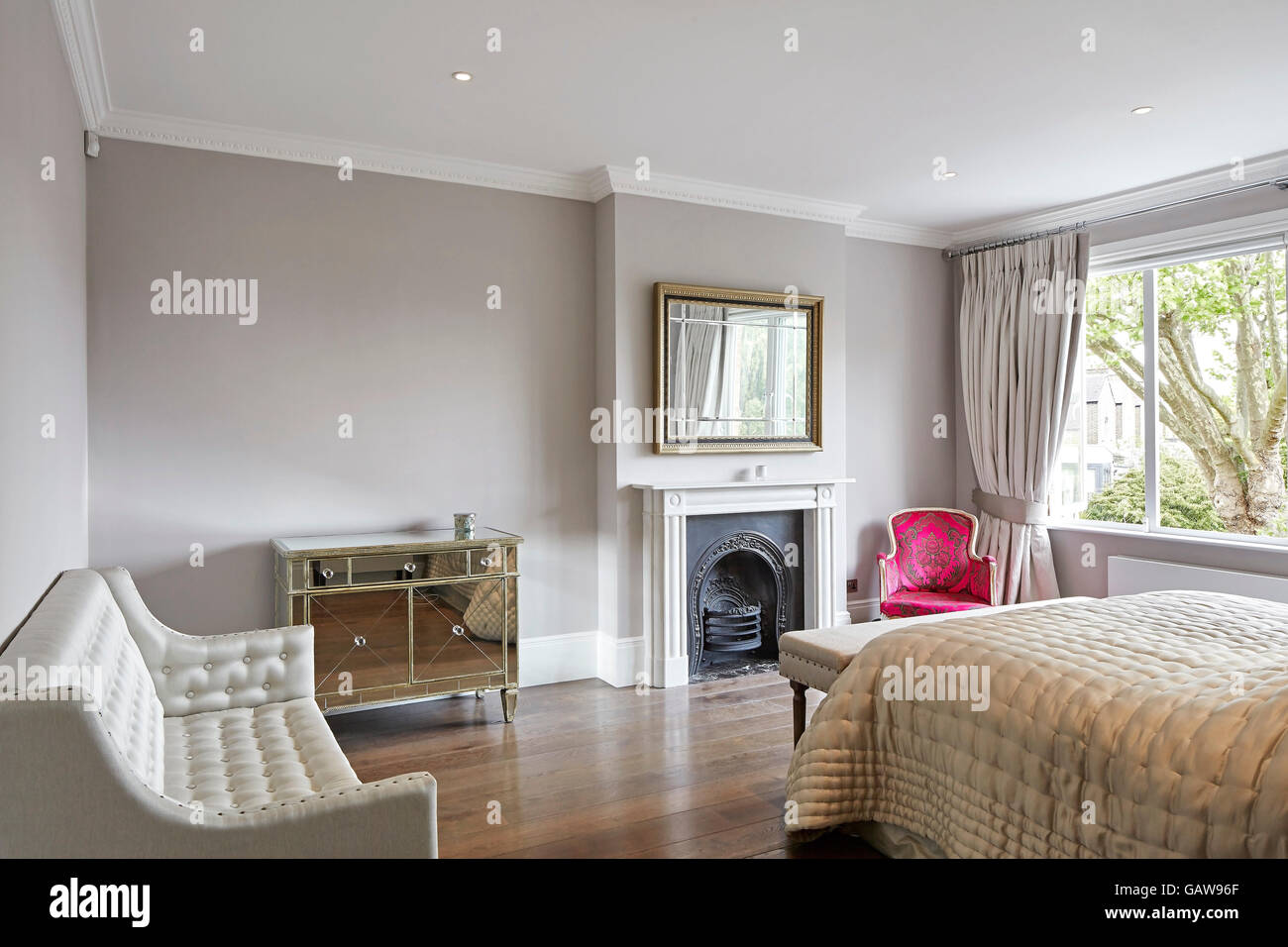 Bedroom with fireplace. Private House, Highlever Road, London, United Kingdom. Architect: Sophie Nguyen Architects, 2015. Stock Photo