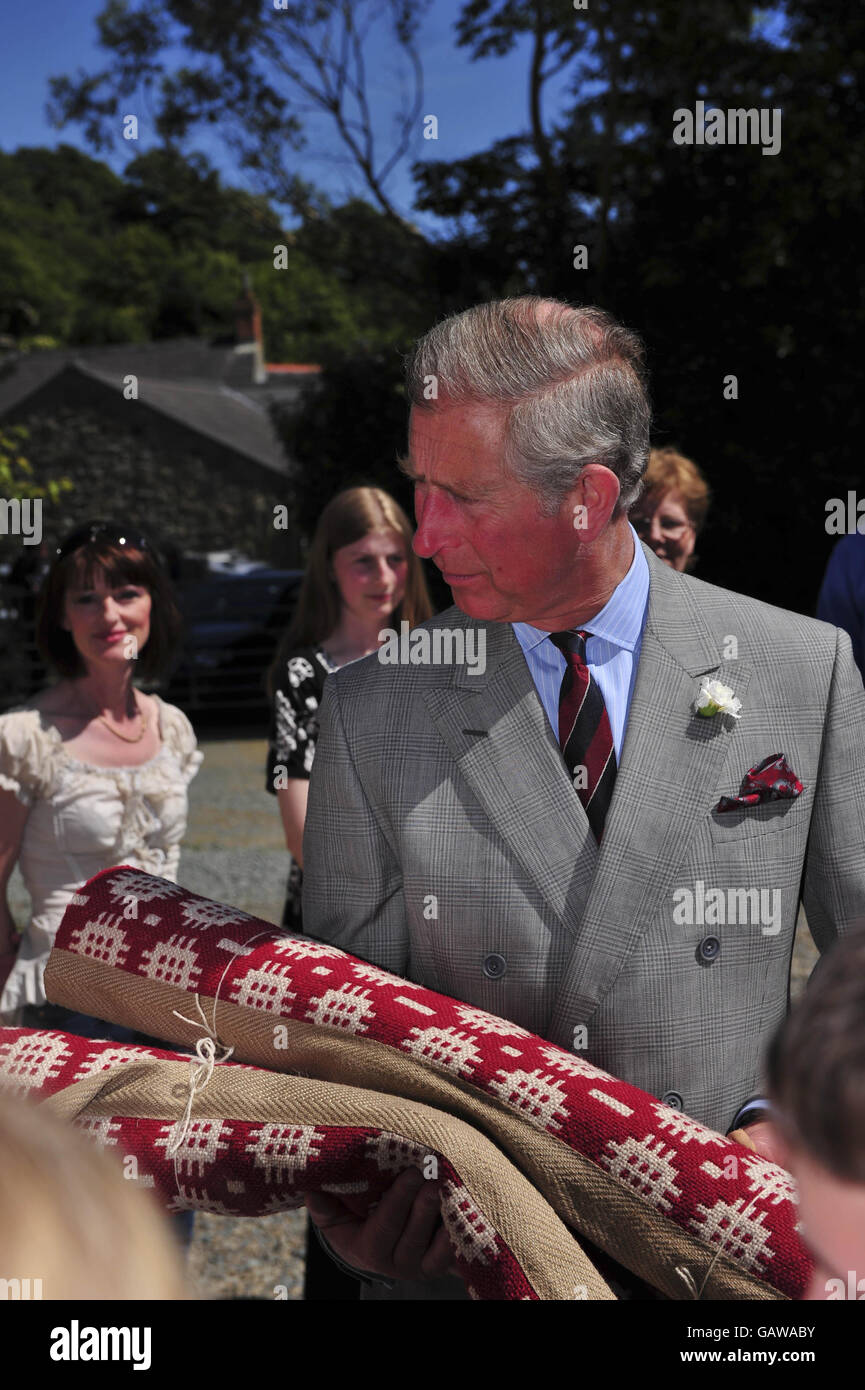 The Prince of Wales receives a wool rug during his tour of Solva Woolen Mill, Solva, Wales. Stock Photo