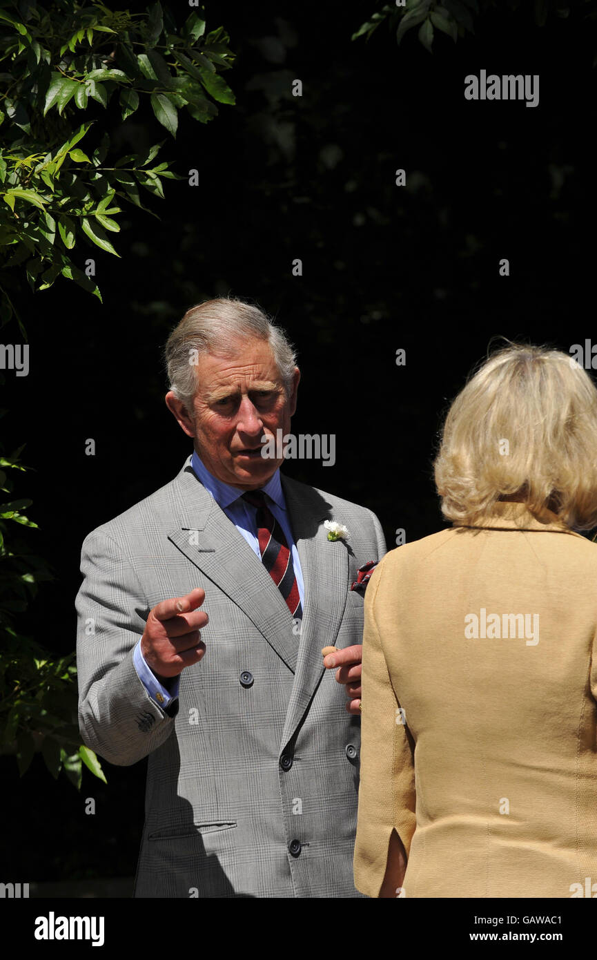The Prince of Wales and the Duchess of Cornwall, (with back to camera) during their tour of Solva Woolen Mill, Solva, Wales. Stock Photo
