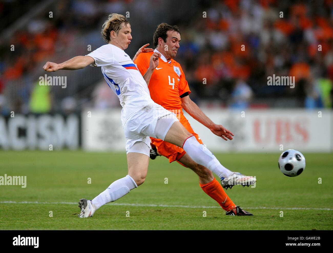 Russia's Roman Pavlyuchenko (left) and Holland's Joris Mathijsen battle for the ball. Stock Photo