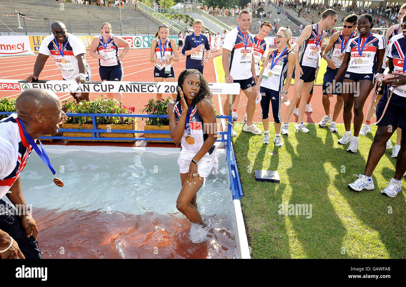 The GB Mens Athletics team celebrate their victory in the Event at the Spar European Cup as they throw their captain Marlon Devonish into the Water Jump where he is joined by Natasha Danvers the Womens Team Captain at Annecy, France. Stock Photo
