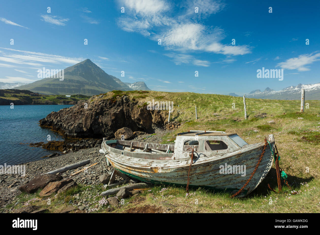 A boat wreck on the shore of an Icelandic fjord Stock Photo Alamy