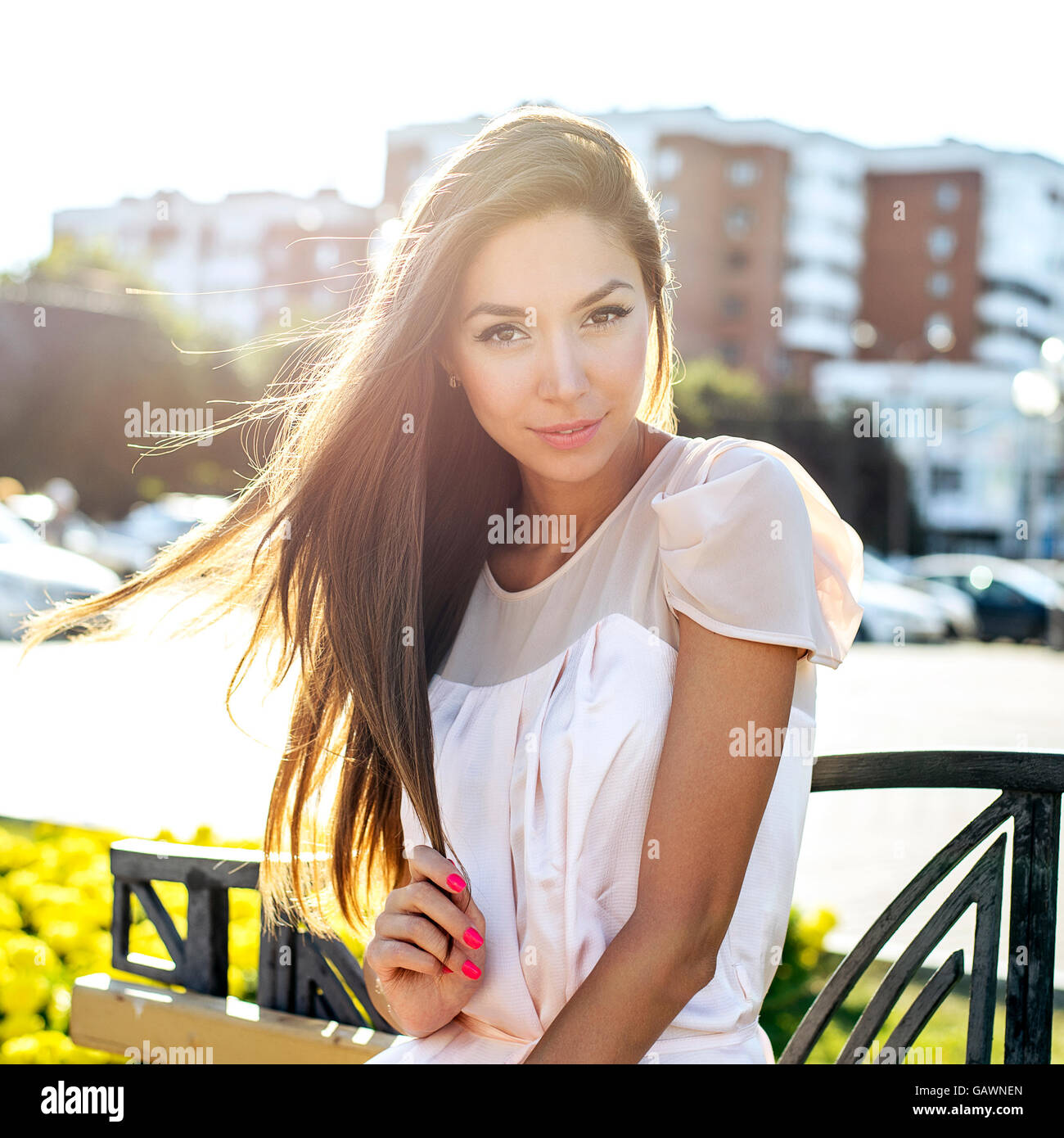 Beautiful girl sitting on a bench, sunny summer day, fashion style ...