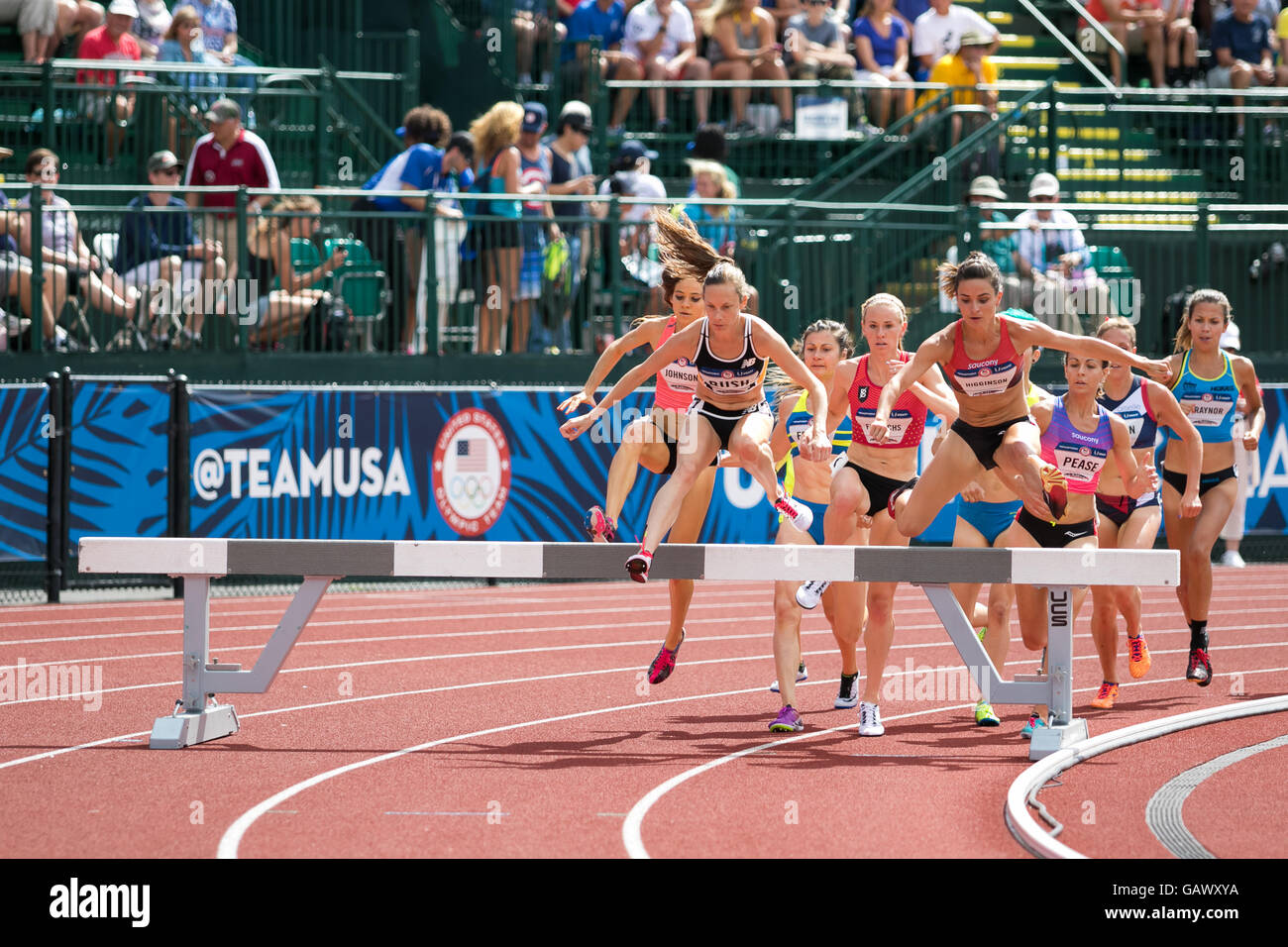 Eugene, USA. 4th July, 2016. Pack of runners jumping over an obstacle