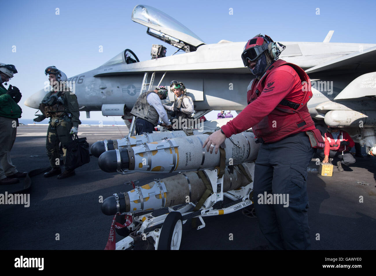 Aviation Ordnancemen transporting rockets on deck of the aircraft carrier USS Dwight D. Eisenhower in the Eastern Mediterranean Sea, 1 July 2016. PHOTO: MARIJAN MURAT/dpa Stock Photo
