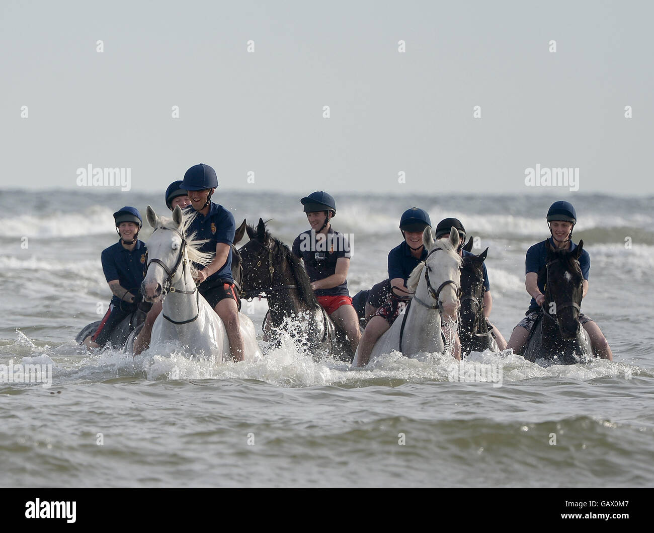 Holkham beach, Norfolk, UK. 6th July, 2016. The Household Cavalry exercise and train on Holkham beach Norfolk as part of their summer break. The horses and riders spend around three weeks summer training at Bodney camp in the heart of the Norfolk countryside close to Thetford, with the main aim for the men to undergo vital training as a regiment without the distraction of public duties. Only a minimum staff remains at the Hyde park barracks during this period to allow as many as possible to attend the training. Credit:  MARTIN DALTON/Alamy Live News Stock Photo