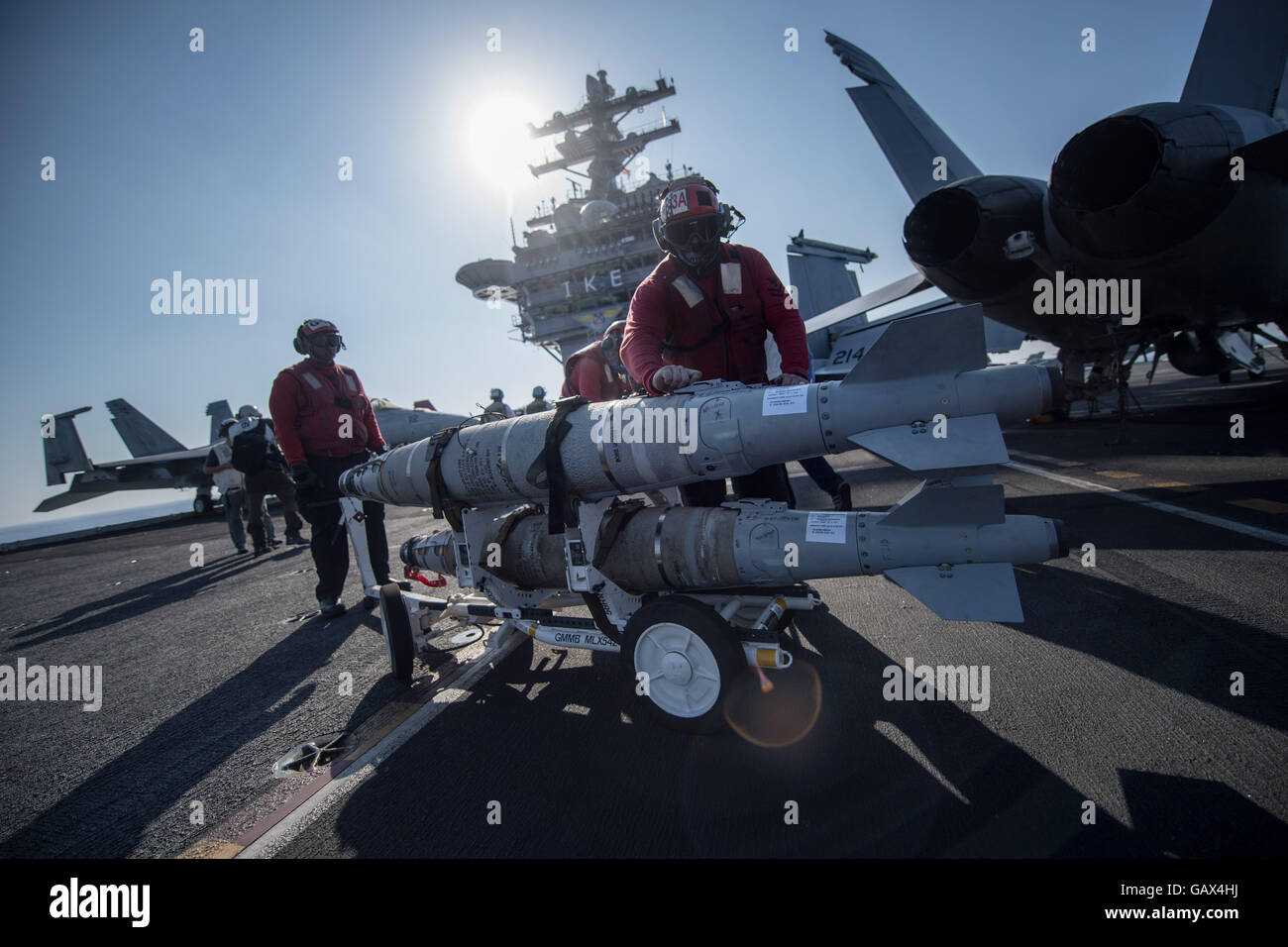 Aviation ordnancemen move missiles on the deck of the aircraft carrier USS Dwight D. Eisenhower in the eastern Mediterranean Sea, 01 July 2016. The images were taken upon invitation by the U.S. Navy. Photo: Marijan Murat/dpa Stock Photo