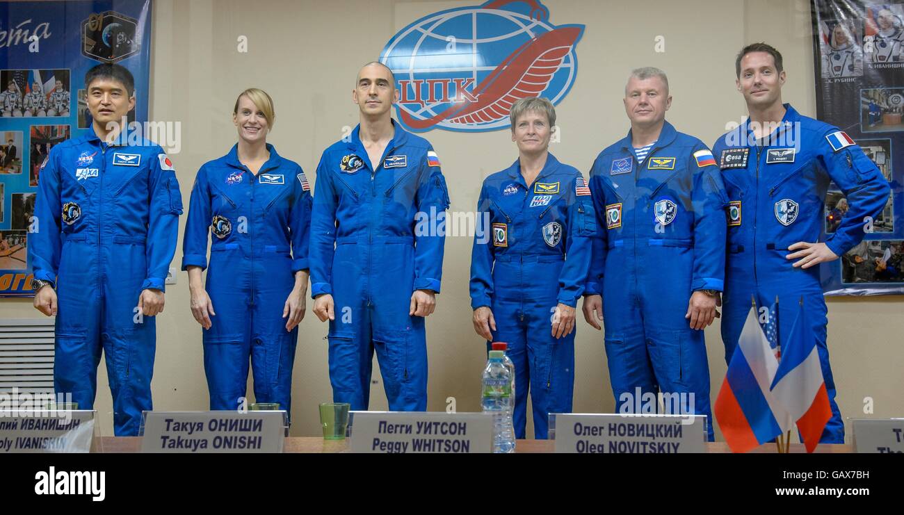 International Space Station Expedition 48 prime and backup crew members in quarantine behind glass during a crew press conference at the Baikonur Cosmodrome July 6, 2016 in Kazakhstan. L-R: Prime crew members:  Japanese astronaut Takuya Onishi, American astronaut Kate Rubins, Russian cosmonaut Anatoly Ivanishin and backup crew members American astronaut Peggy Whitson, Russian cosmonaut Oleg Novitskiy and French astronaut Thomas Pesquet. Stock Photo