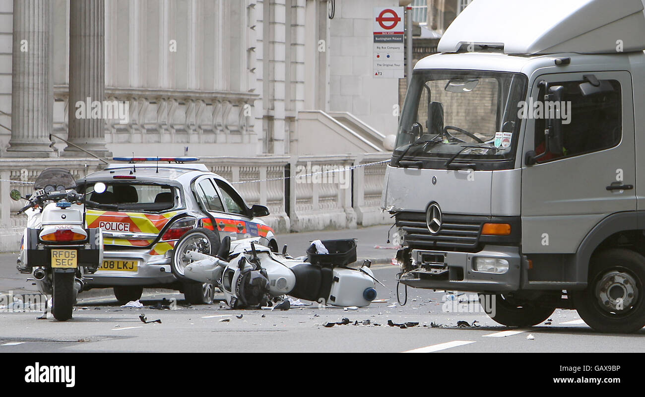Police attend the scene of an accident involving a Police motorcycle and a lorry on Buckingham Gate, central London. Stock Photo