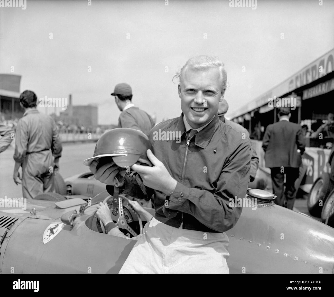 Formula One Motor Racing - British Grand Prix - Aintree - Practice. Mike Hawthorn shows off his new nylon helmet Stock Photo