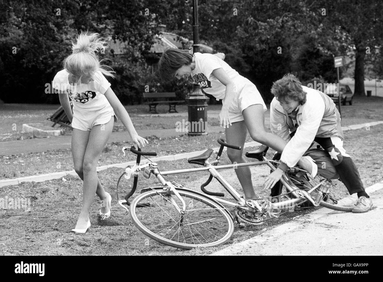 Blue Peter presenter Peter Duncan helping out Tea Council girl Sarah Oakes, left, after falling from a tandem bicycle, as he launched the Raleigh Charity Ride cycle marathon in Hyde Park. Stock Photo