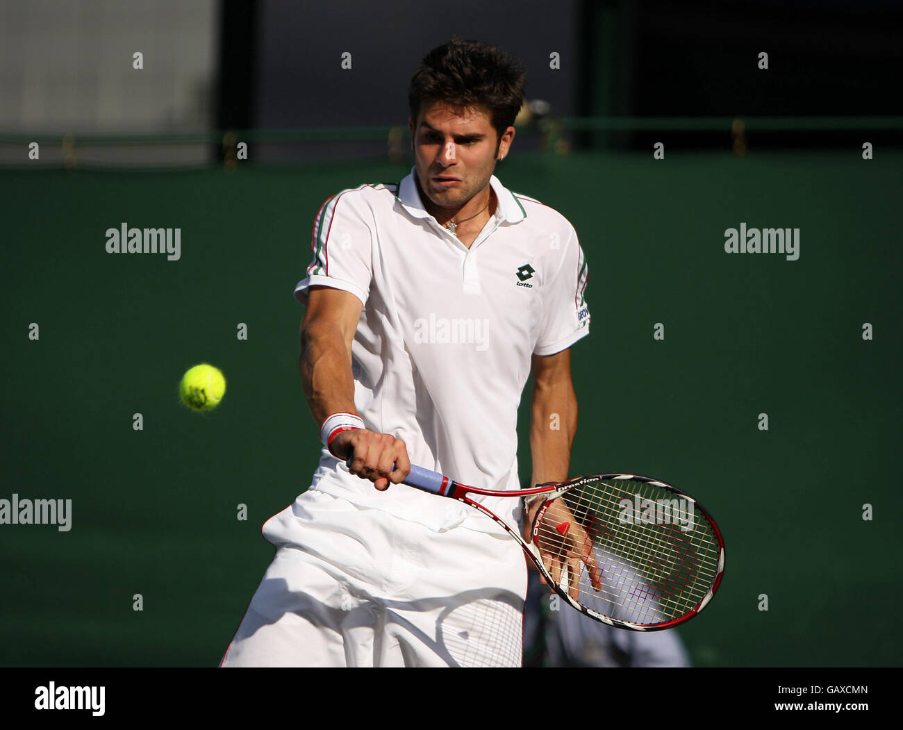 Italy's Simone Bolelli against Chile's Fernando Gonzalez during The Wimbledon Championships at The All England Lawn Tennis Club, Wimbledon, London. Stock Photo
