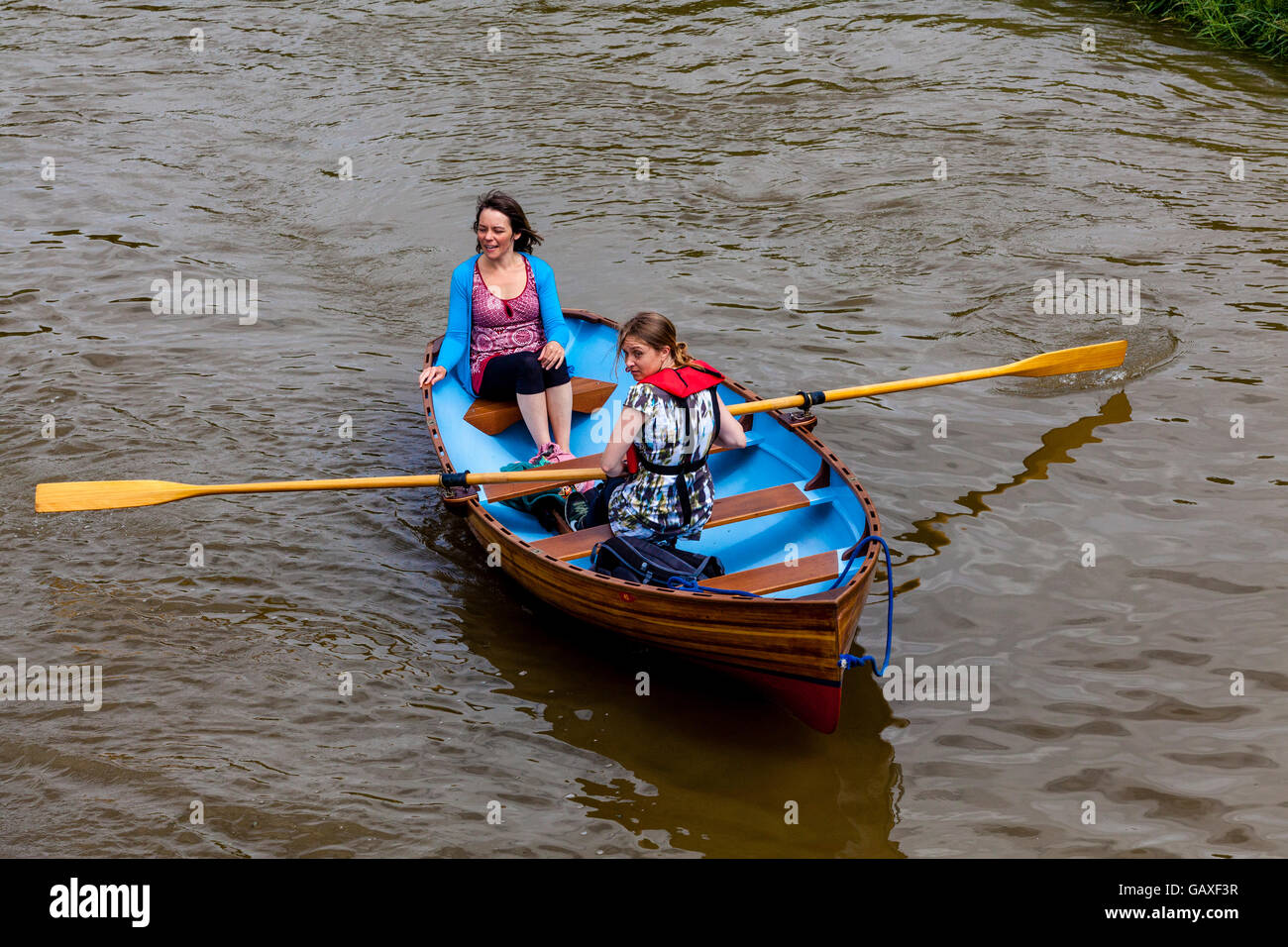 Two Women In A Rowing Boat On The River Ouse, Lewes, Sussex, UK Stock Photo