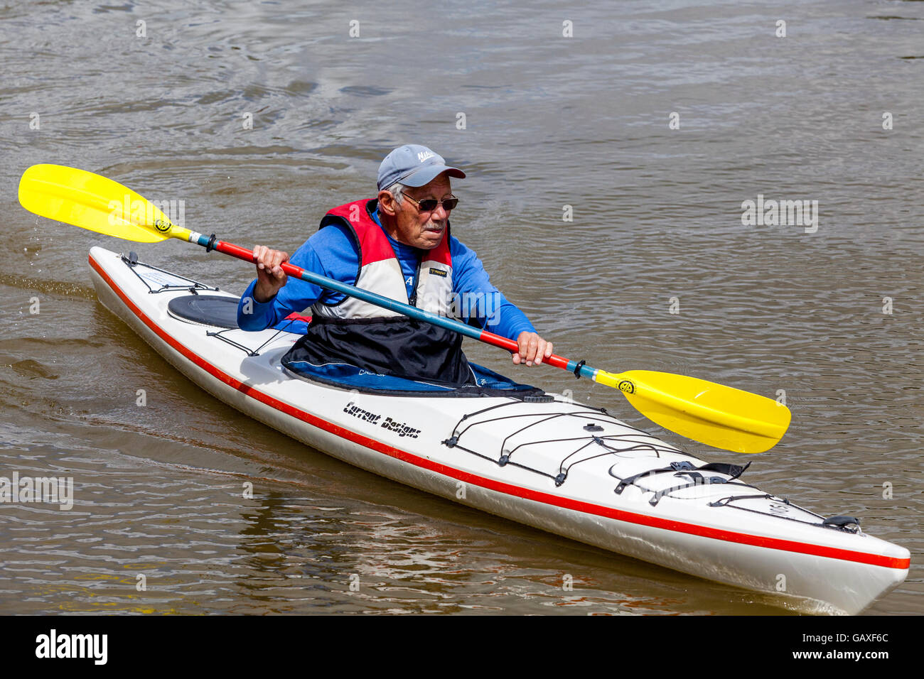 An Elderly Man Kayaking On The River Ouse, Lewes, Sussex, UK Stock Photo