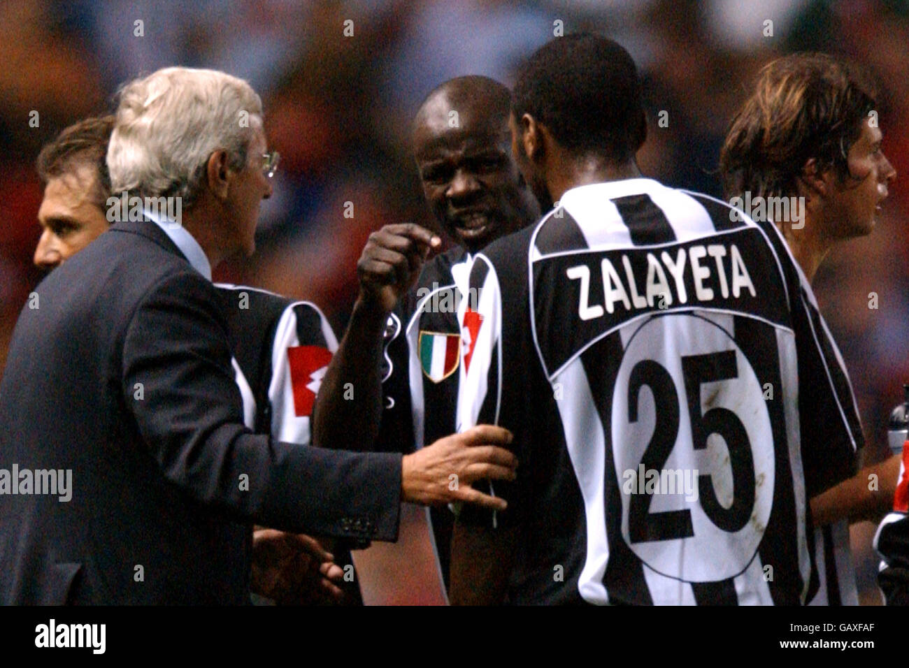 Juventus' Lilian Thuram (c) points an accusing finger at teammate Marcelo Danubio Zalayeta (r) as coach Marcello Lippi (l) looks on Stock Photo
