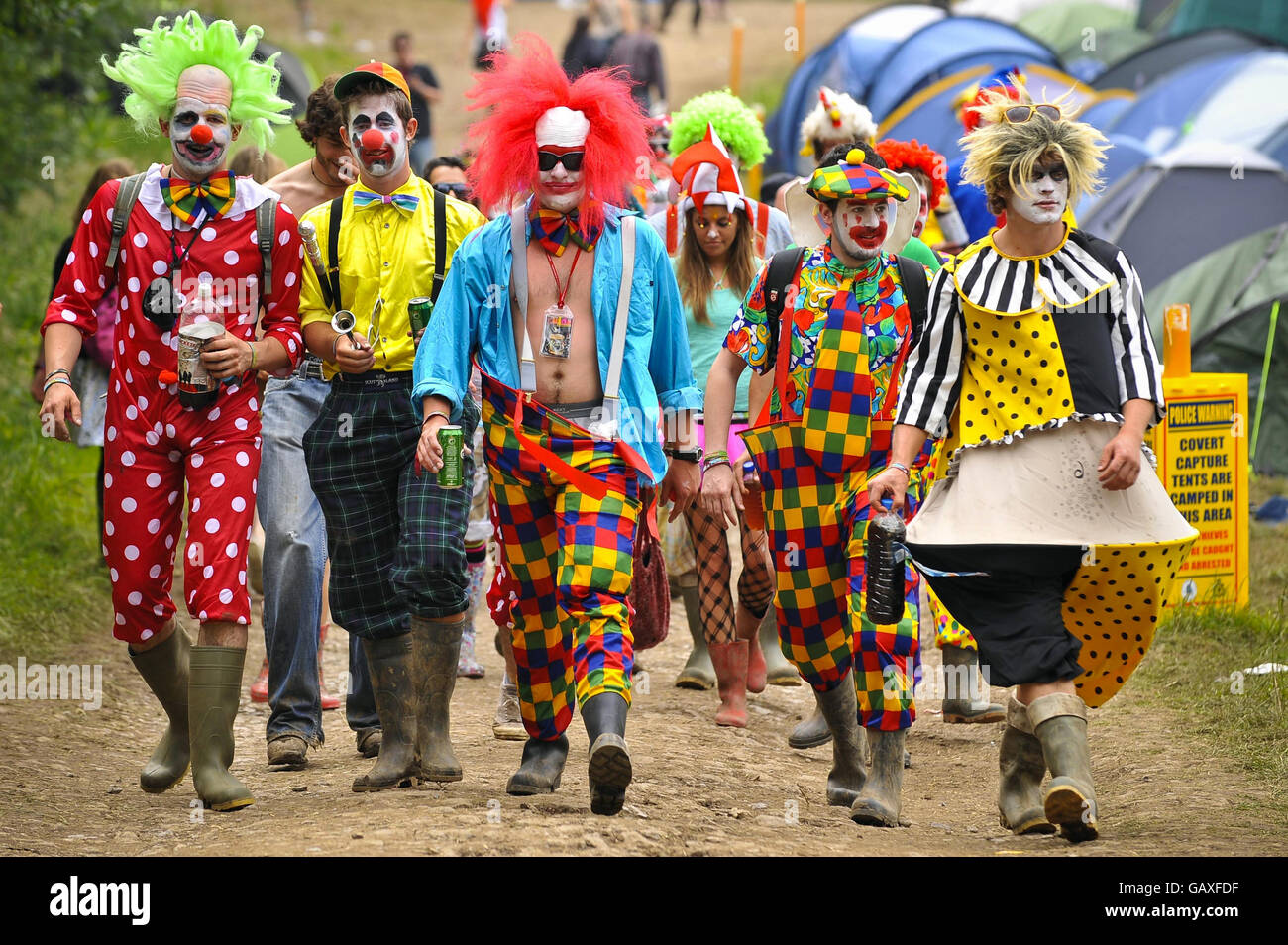 Glastonbury Festival 2008 - Day Two. A group revellers dressed up as colourful clowns during day two of the Glastonbury Festival, Somerset. Stock Photo