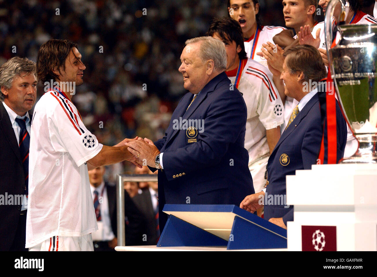 AC Milan's Paolo Maldini (l) is presented with his winners medal by UEFA President Lennart Johansson and UEFA Chief Executive Gerhard Aigner (r) Stock Photo