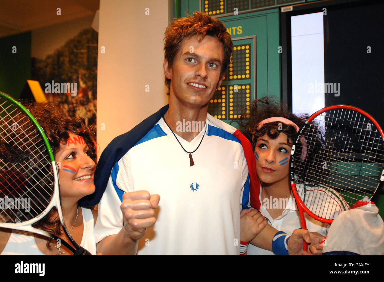 Wimbledon tennis fans pose for pictures with a waxwork of British tennis player Andy Murray at Madame Tussauds in central London. Stock Photo