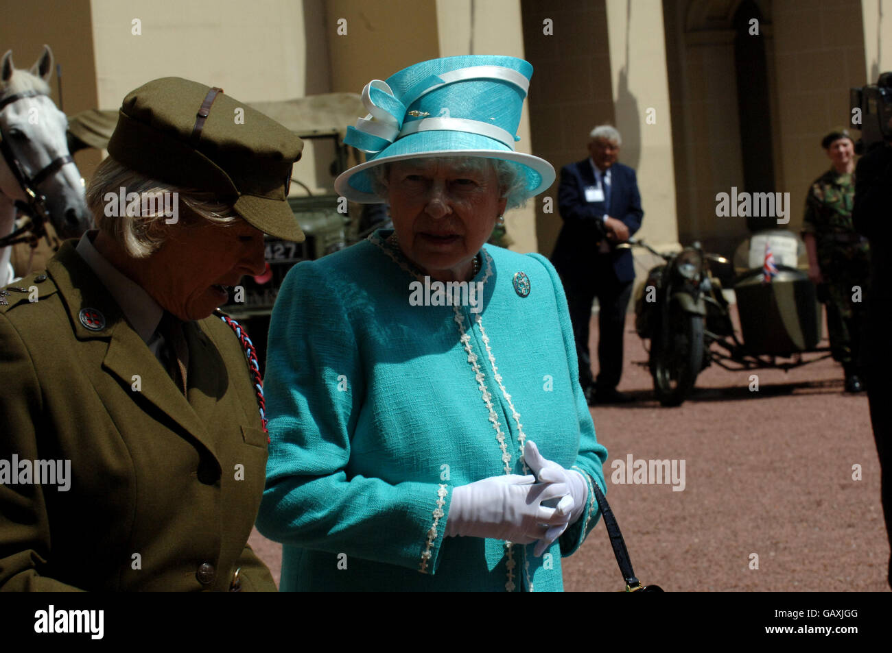 The Queen inspects Vintage vehicles used by the First Aid Nursing Yeomanry during WWII, which were assembled in the quadrangle of Buckingham Palace, London. Stock Photo