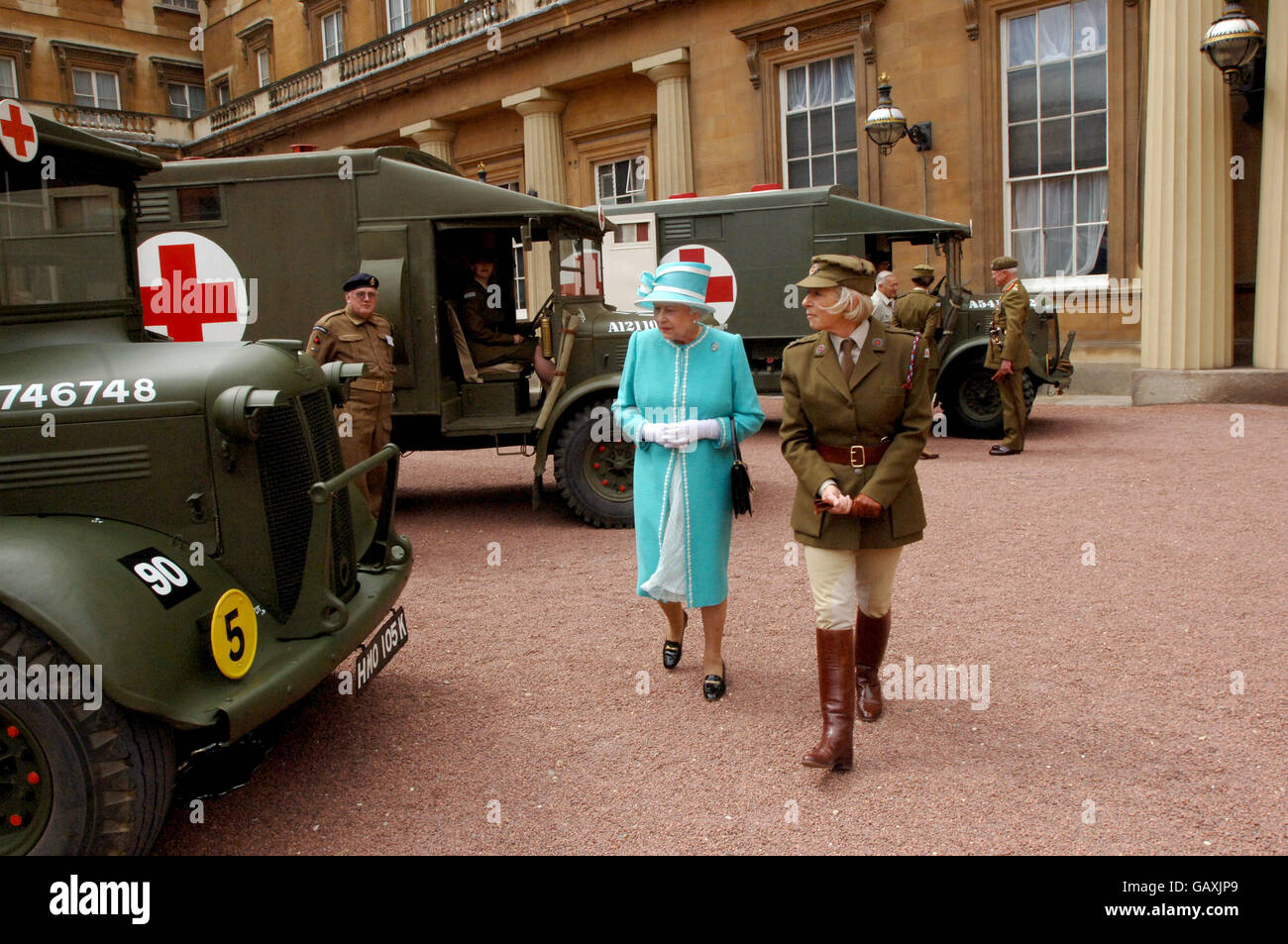 Britain's Queen Elizabeth II, inspects vintage vehicles used by the First Aid Nursing Yeomanry during WWII, which were assembled in the quadrangle of Buckingham Palace, London. Stock Photo