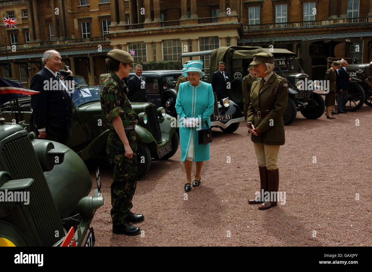 Britain's Queen Elizabeth II, inspects vintage vehicles used by the First Aid Nursing Yeomanry during WWII, which were assembled in the quadrangle of Buckingham Palace, London. Stock Photo