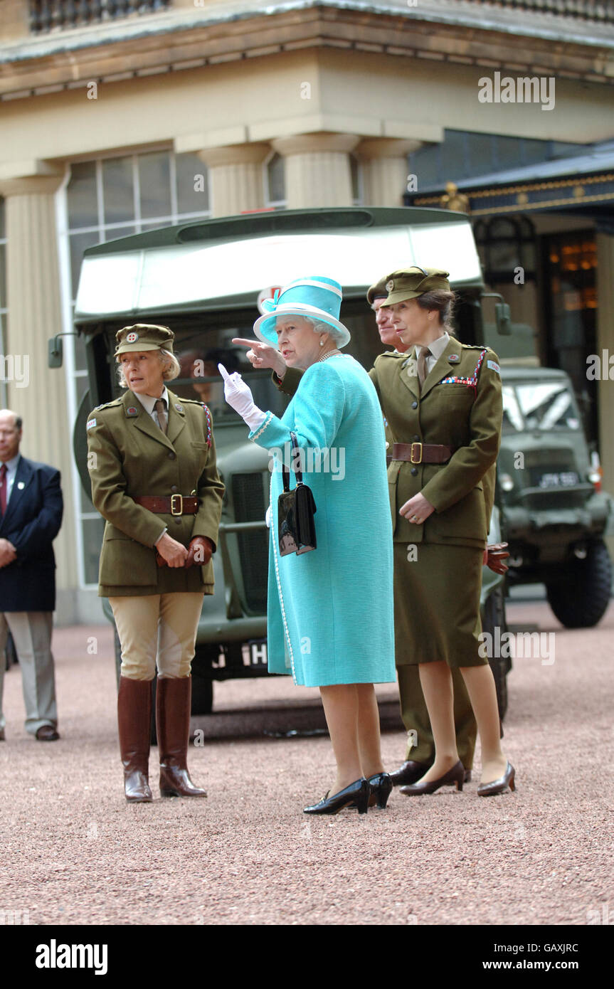 The Queen and The Princess Royal, who is Commandant-in-Chief of the First Aid Nursing Yeomany, arrives to inspect vintage vehicles used by the yeomanry after they assembled in the quadrangle of Buckingham Palace, London to mark the centenary of the yeomanry. Stock Photo