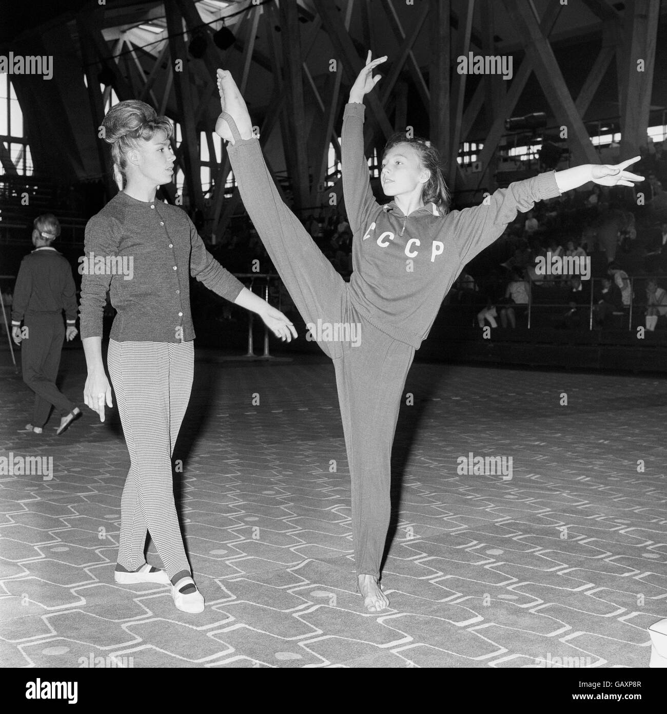 Russian gymnasts Natalia Kutchinskaya practises under the watchful eye of Larissa Latynina, the world's finest women's gymnast she was here with eight other Soviet gymnasts to appear in four exhibition performances in London. Stock Photo