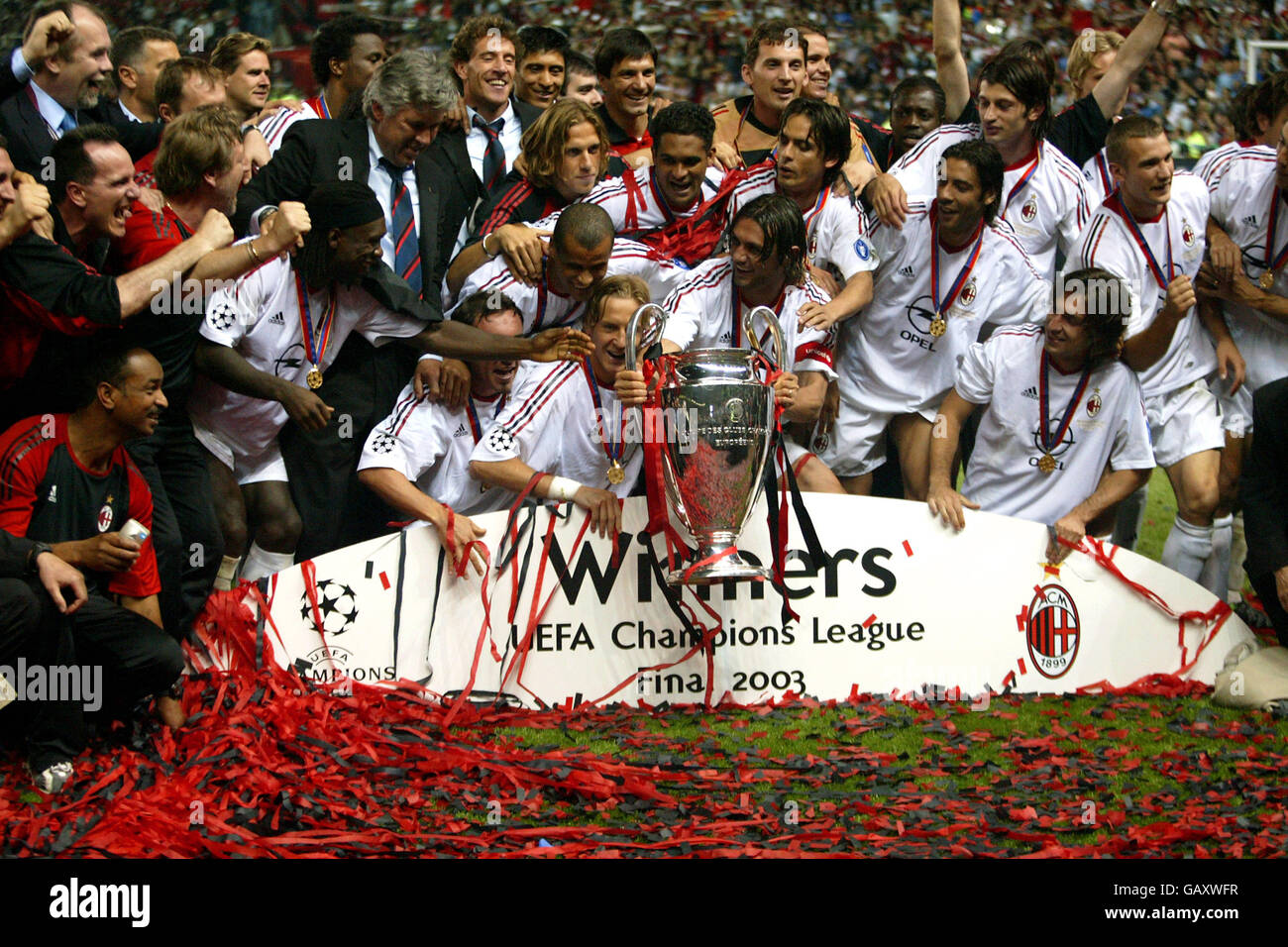 AC Milan players get their hands on the UEFA Champions League trophy as they celebrate their win against Juventus (c) captain Paolo Maldini Stock Photo