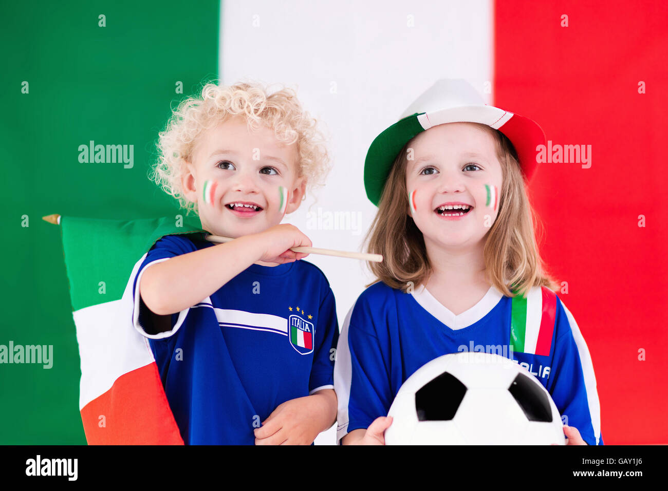 Children cheering and supporting Italian national football team. Kids
