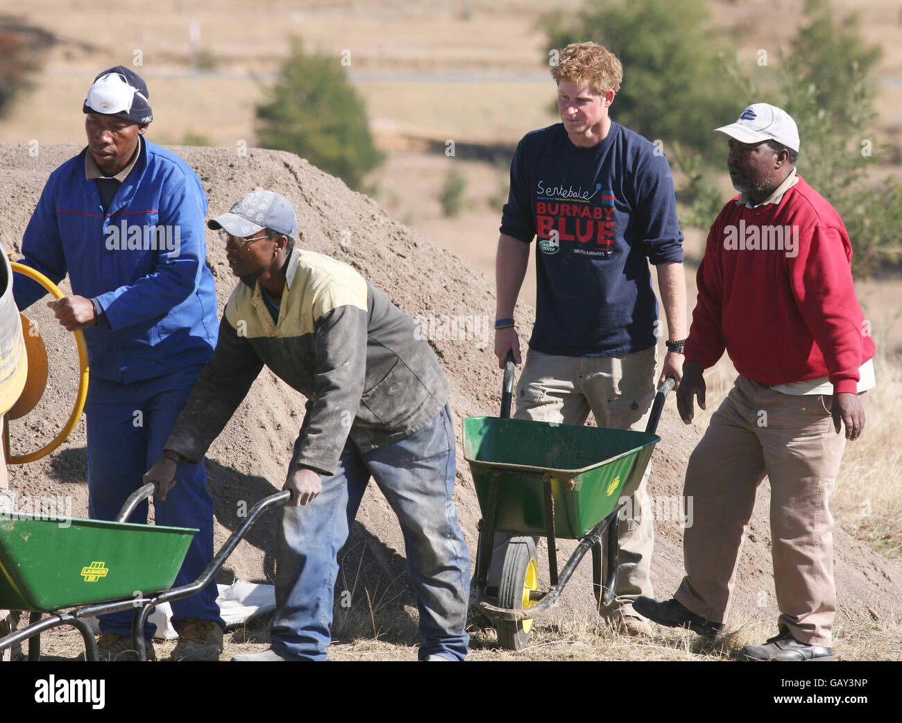 Prince Harry with members of the Household Cavalry Regiment and local