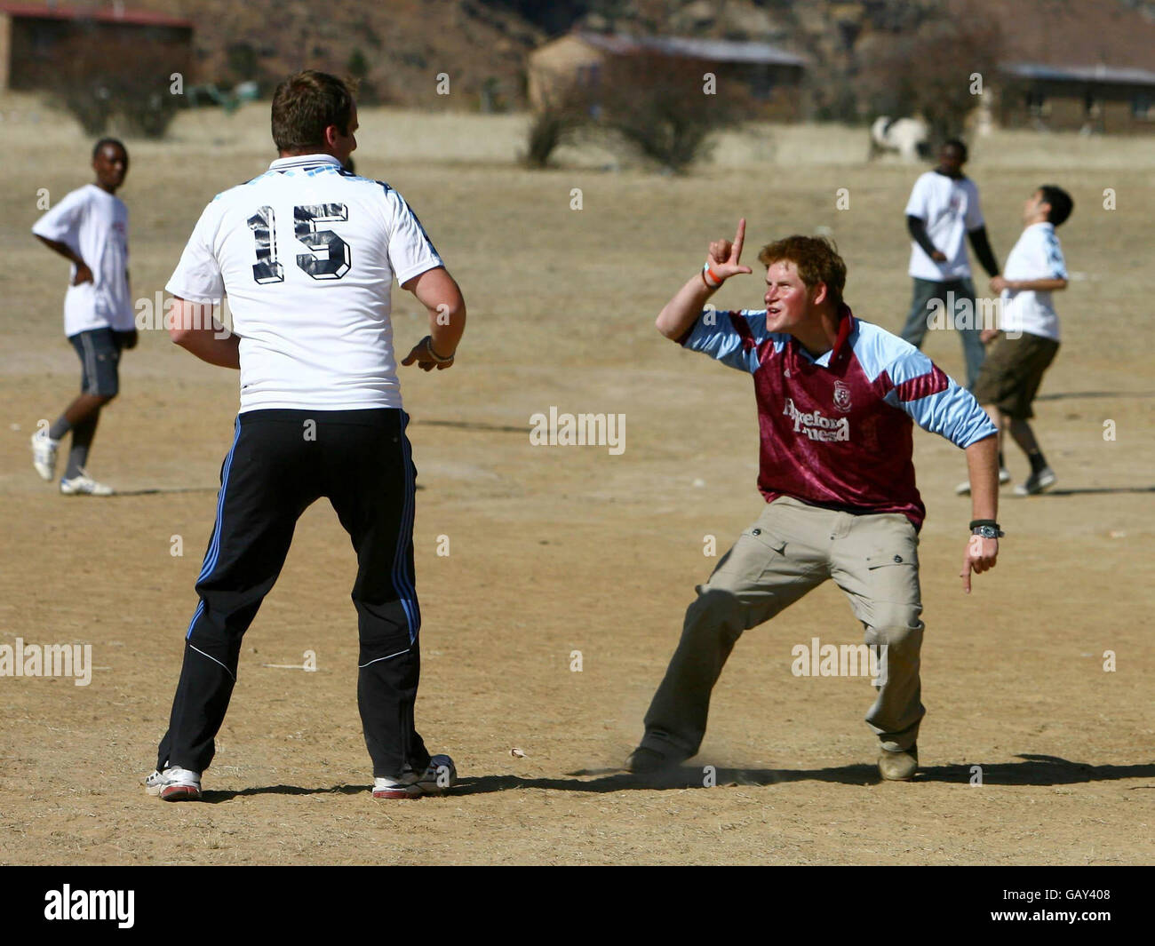 Prince Harry shares a joke with The Sun royal reporter Duncan Larkham (left) during a 'Kick 4 Life' football match at the Thuso Centre for disabled children in Lesotho, Africa. Stock Photo
