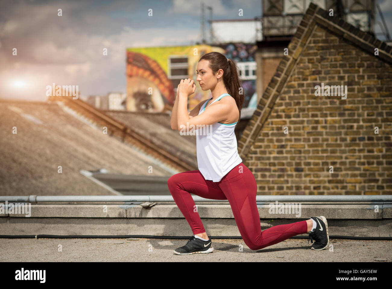 Sporty woman wearing fitness wear stretching Stock Photo