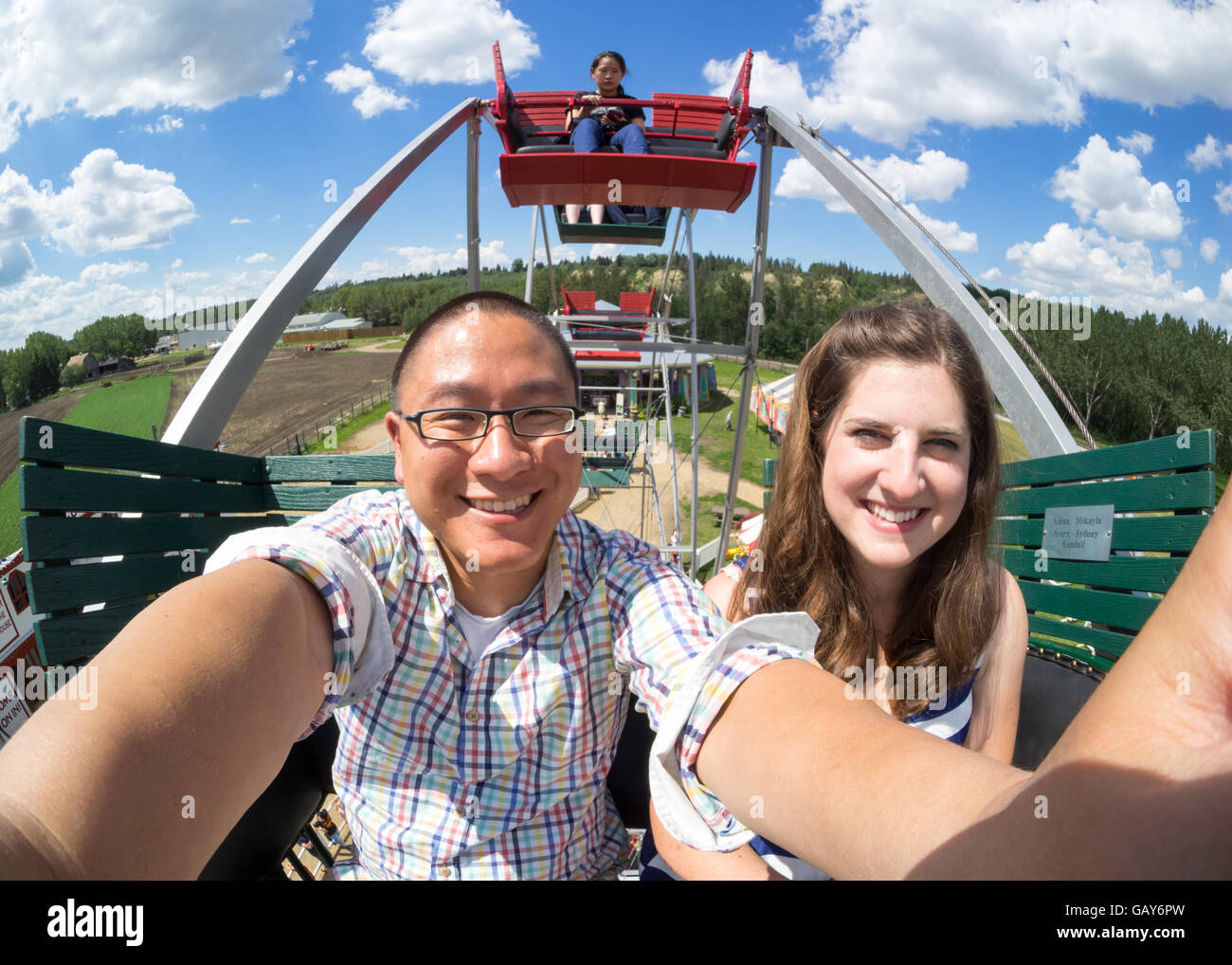 An interracial couple take a selfie on a Ferris wheel at Fort Edmonton Park in Edmonton, Alberta, Canada. Stock Photo