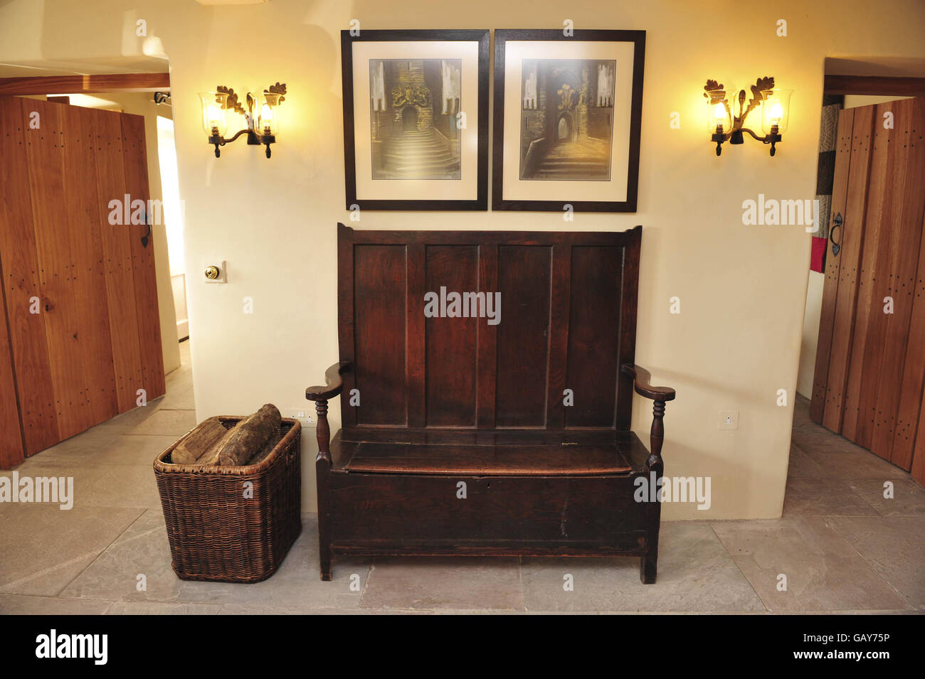 A view of a wooden bench and paintings inside the entrance hallway