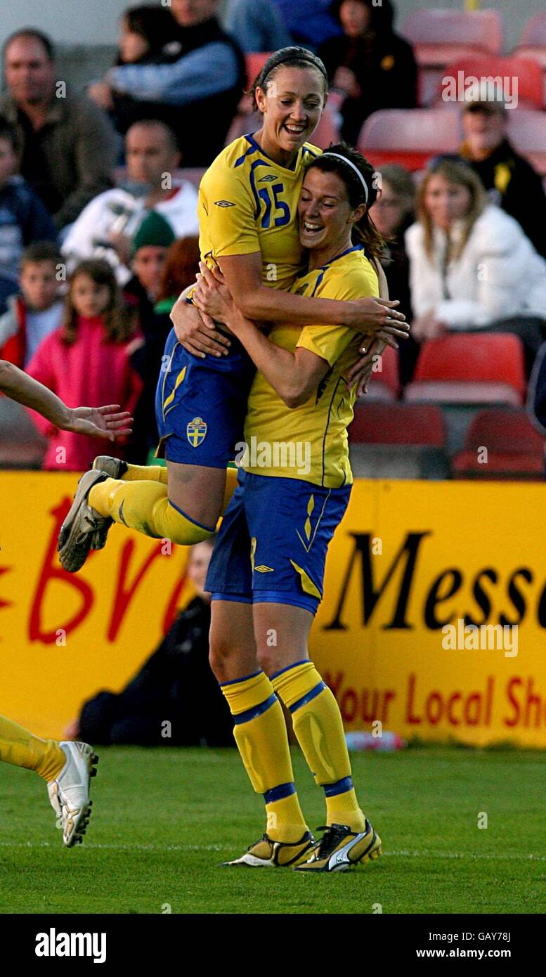 Swedens lotta schelin celebrates her goal with therese suogran hires