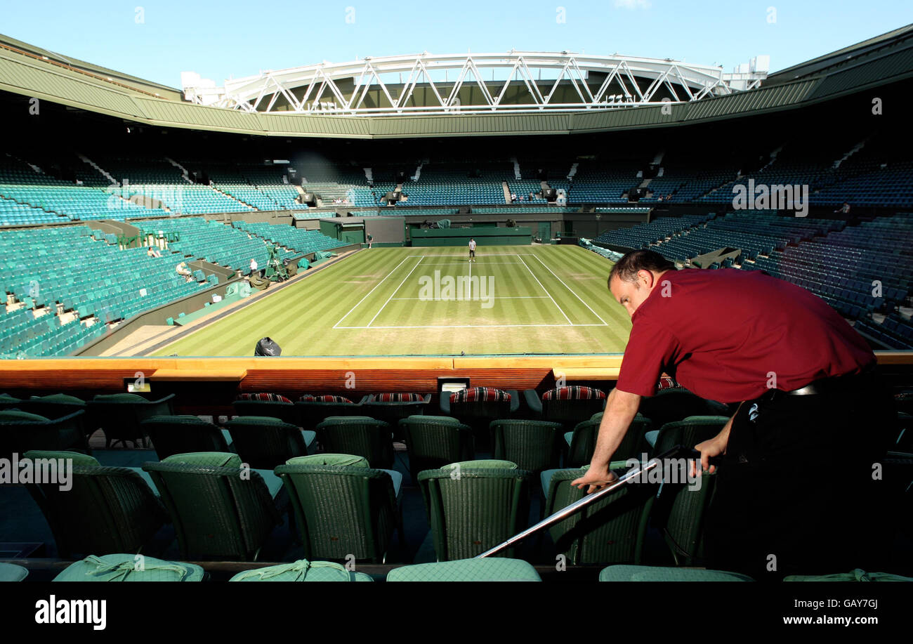 Tennis - Wimbledon Championships 2008 - Day Four - The All England Club. A grounds man cleans the Royal Box on Centre Court during the Wimbledon Championships 2008 at the All England Tennis Club in Wimbledon. Stock Photo