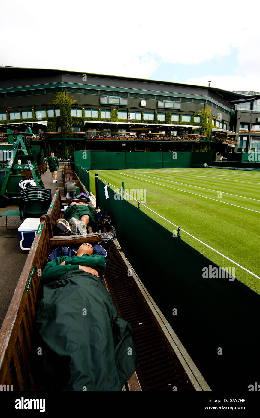 A Wimbledon court attendant takes a break prior to the start of the