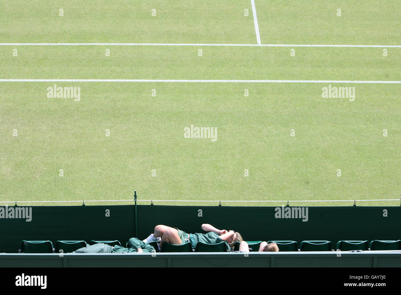 A Wimbledon court attendant takes a break prior to the start of the