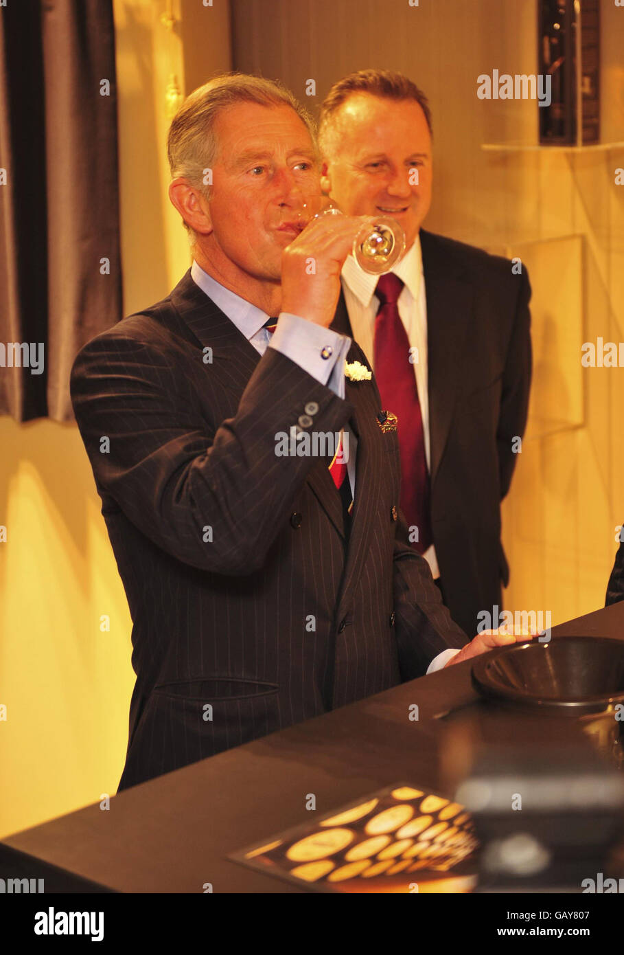 The Prince of Wales enjoys a sip of whisky made at the Welsh Whisky Company Penderyn Distillery especially for the Prince, which is not available to the public and is cask strength at 56.2 Alcohol By Volume . Stock Photo