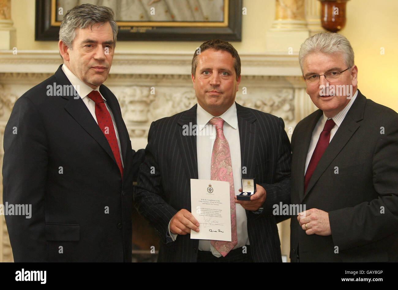 Prime Minister Gordon Brown and Defence Secretary Des Browne present a Veterans Award to Chris Burns, Royal Corp of Transport, at a Downing Street reception ahead of Veterans Day on June 27th. Stock Photo