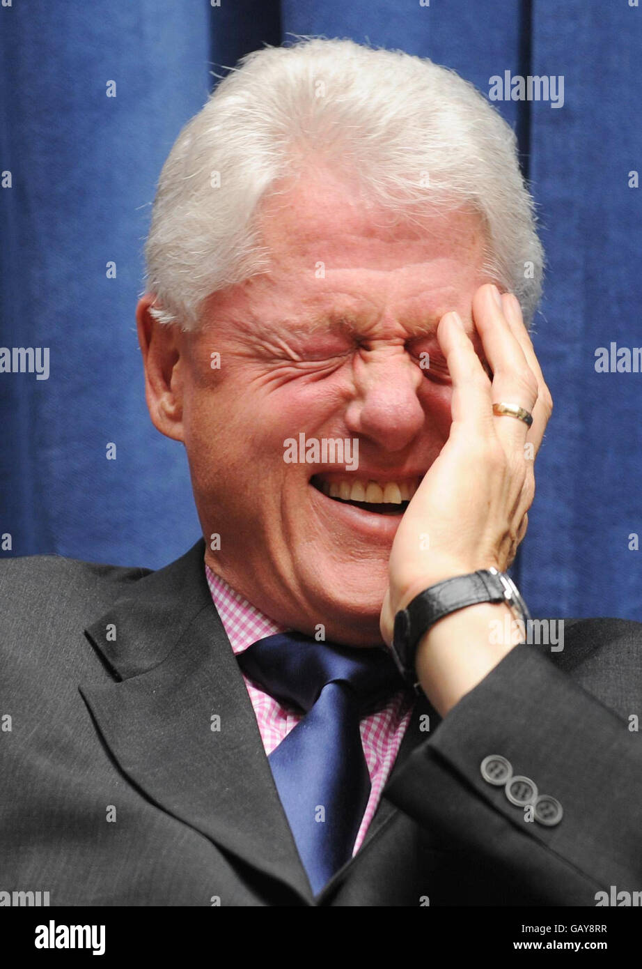 President Bill Clinton laughs at a joke made by Sir Bob Geldof at the Department for International Development in London today where he announced a new partnership to end rural poverty in Rwanda and Malawi. Stock Photo