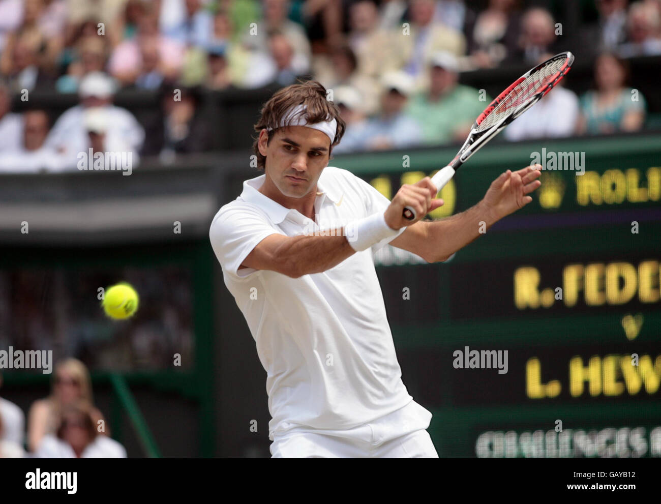 Switzerland's Roger Federer in action against Australia's Lleyton Hewitt during the Wimbledon Championships 2008 at the All England Tennis Club in Wimbledon. Stock Photo
