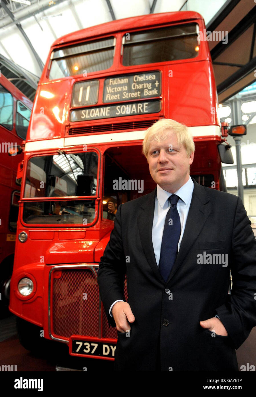 Mayor of London, Boris Johnson stands in front of a London Transport Routemaster bus, at the London Transport Museum in central London. Stock Photo