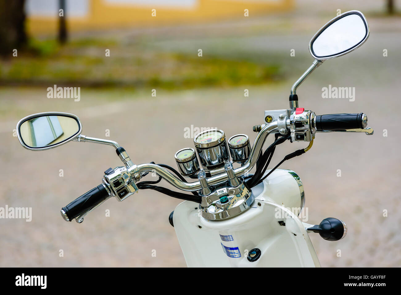 Motala, Sweden - June 21, 2016: Baotian retro 2013 moped handlebar. Window visible in one mirror. Stock Photo