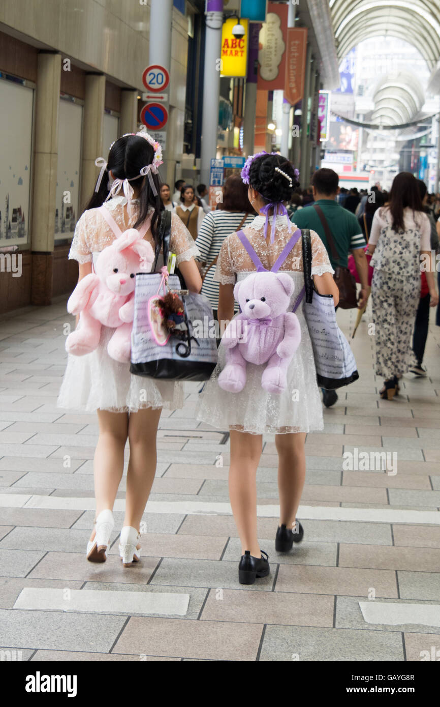 Two Japanese girls in matching outfits and teddy bear backpacks. Stock Photo