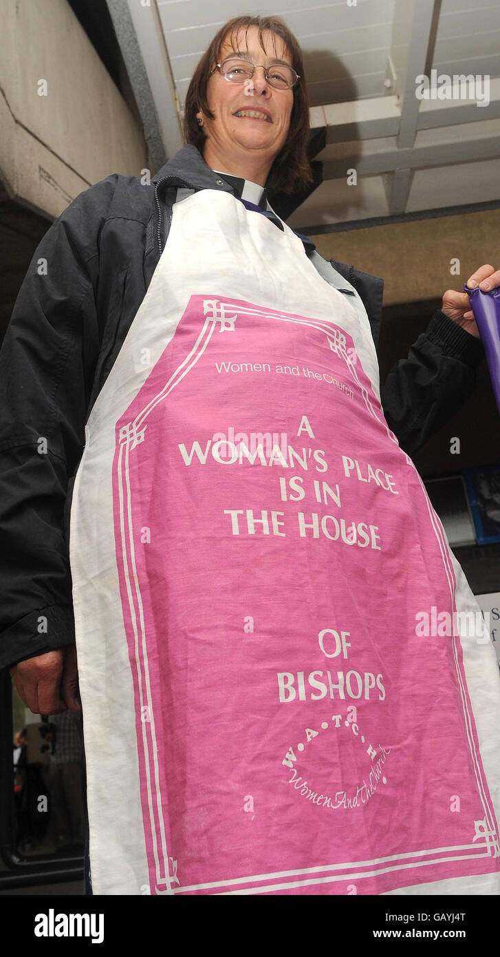 Jennifer Zarek from WATCH (Women And The Church) wears an apron outside the hall, before taking her seat for the debate on Women Bishops, being held today at the General Synod in Central Hall, York University. Stock Photo