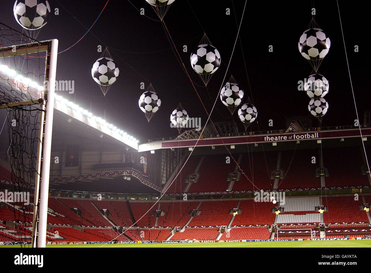 Giant inflatable footballs are blown up and suspended from the roof at Manchester United's Old