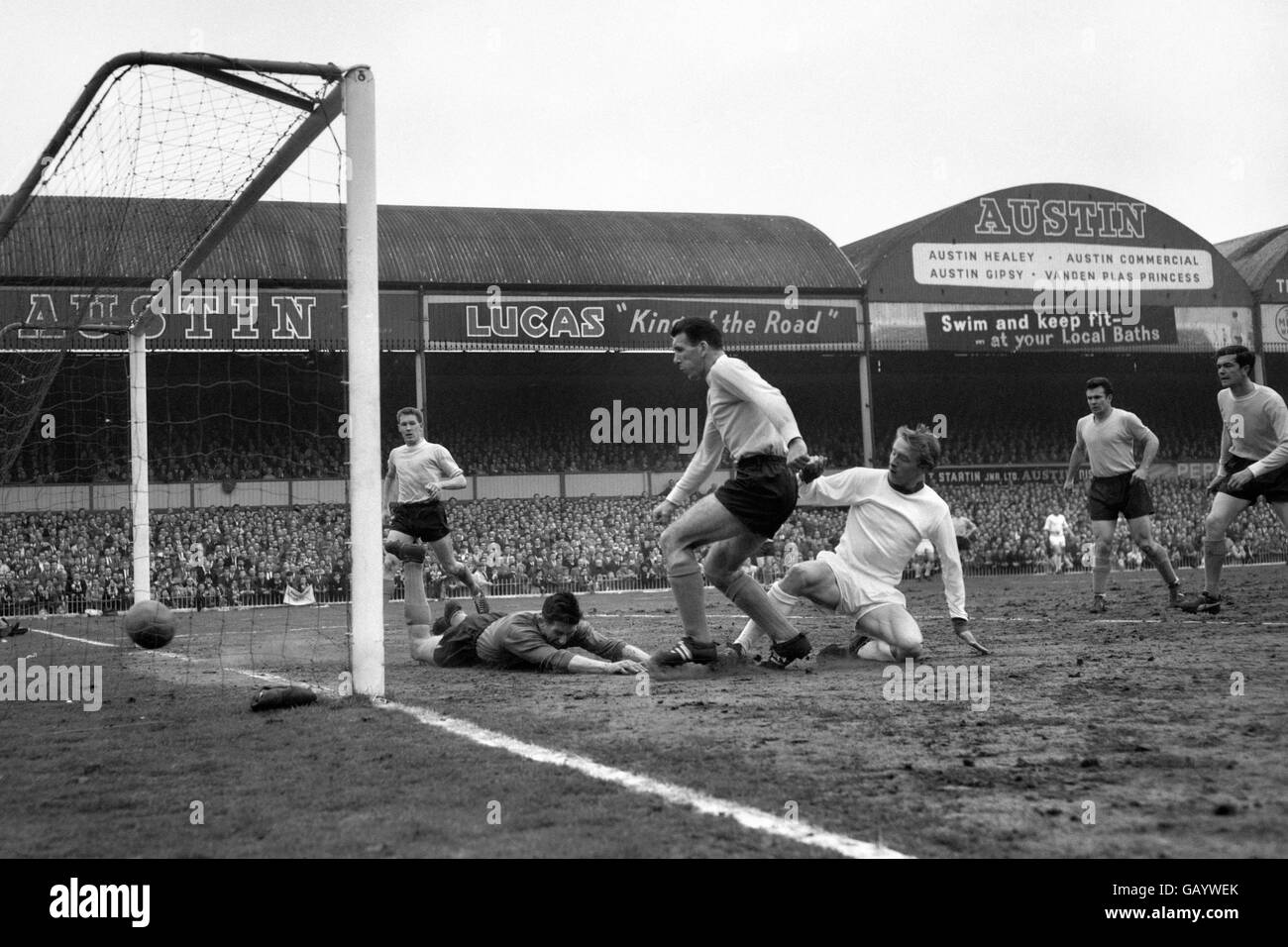Denis Law, United inside left (right) slides the ball past Southampton goalkeeper Reynolds to score the only goal of th match. The goal put his team in the Wembley final against Leicester. Stock Photo