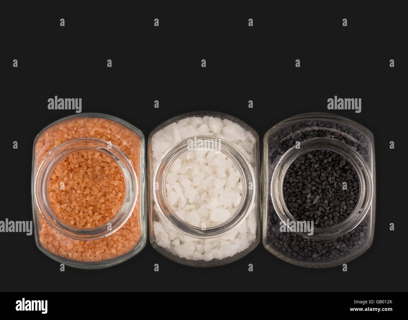 Two glass containers with Red Alaea Sea Salt and Black Lava Sea Salt