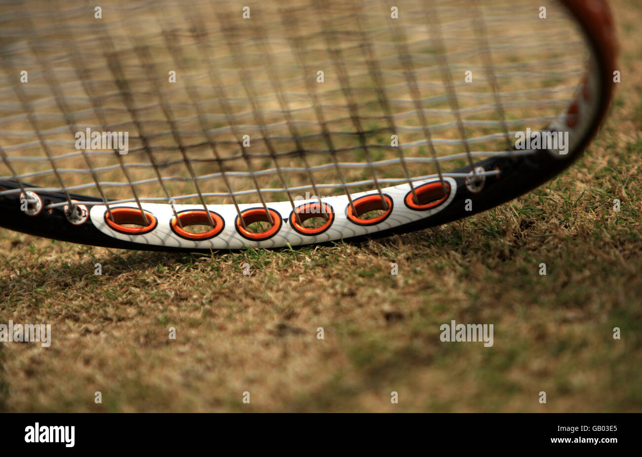 Tennis - Wimbledon Championships 2008 - Day Eleven - The All England Club. Tennis racket on worn grass Stock Photo